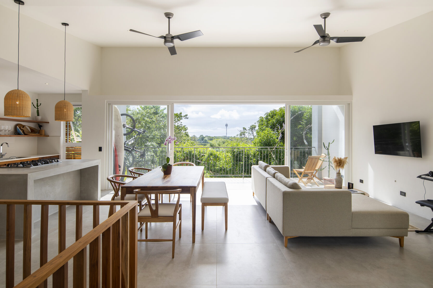 Living and dining area opening to forest view